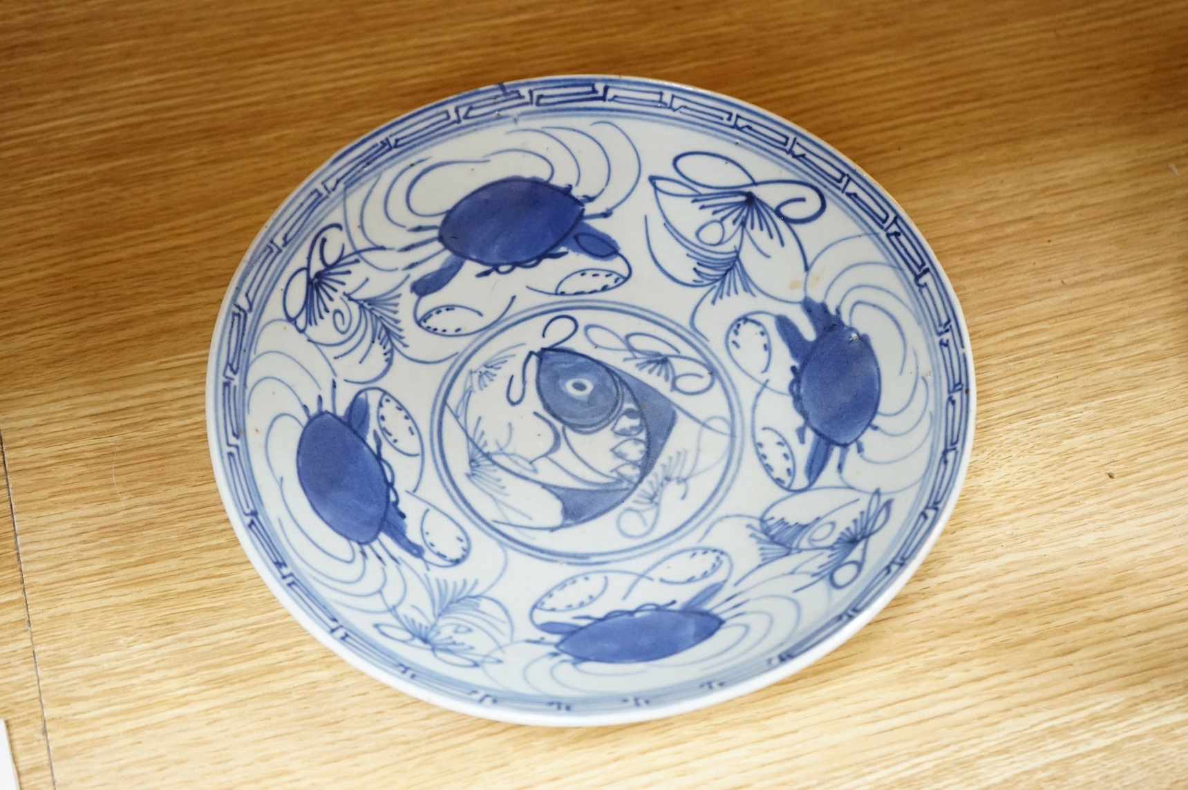 A 18th century Chinese export blue and white octagonal serving dish and two blue and white dishes, largest 38cm wide. Condition - one plate cracked